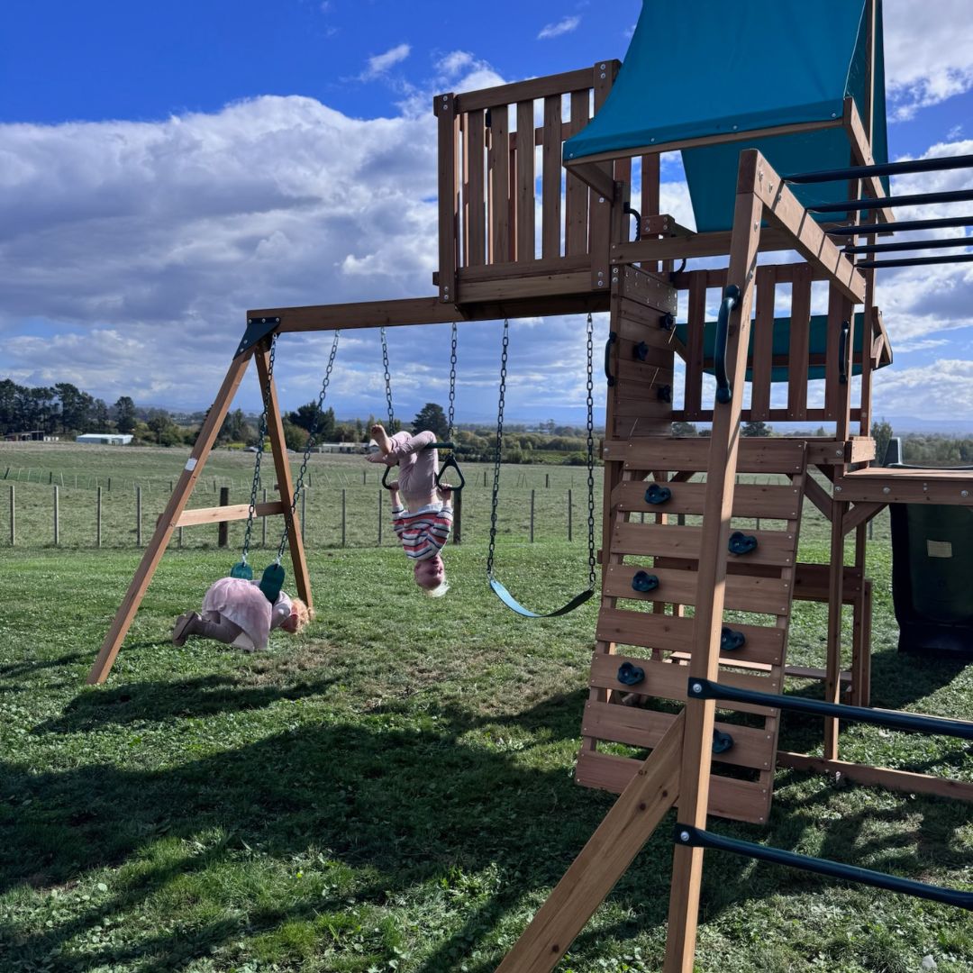 Crow's Nest Play Centre With Children Playing On 3-Station Swing Set