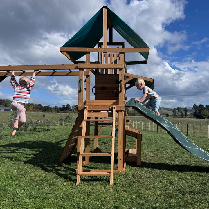 Crow's Nest Play Centre With Children Playing On Monkey Bars And Slide