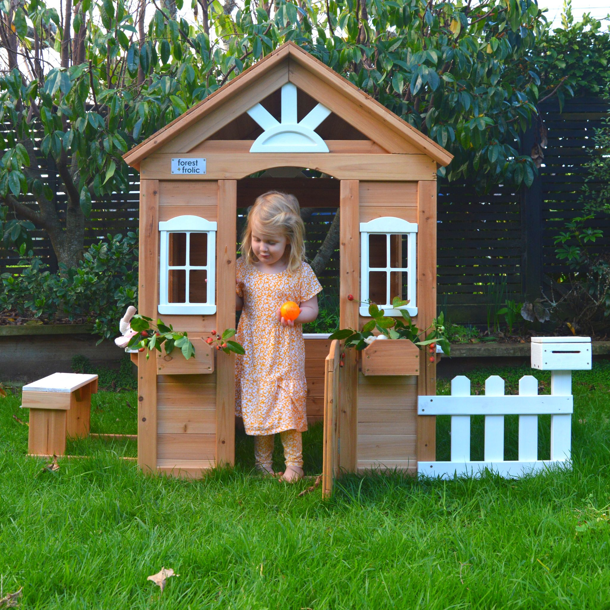 Girl Having Fun In Cubby Playhouse