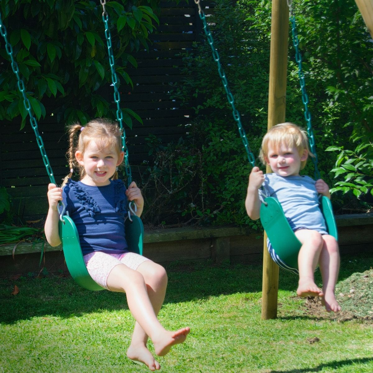 Kids Swinging On Wooden Swing Set