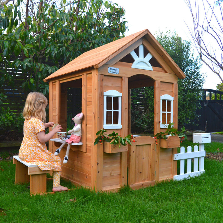 Girl Serving Tea To Stuffed Animal In Cubby Playhouse