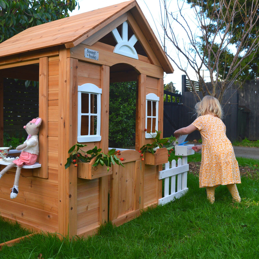 Girl Using Letterbox Of Cubby Playhouse